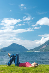 Woman relaxing enjoying at the fjord coast