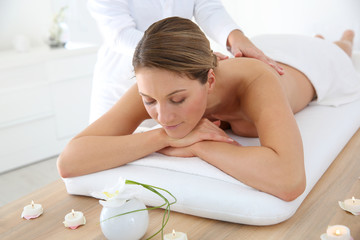 Woman in spa institute receiving oil massage