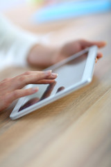 Closeup of hand sliding on digital tablet