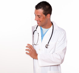 Fototapeta premium Attractive male doctor holding a white placard