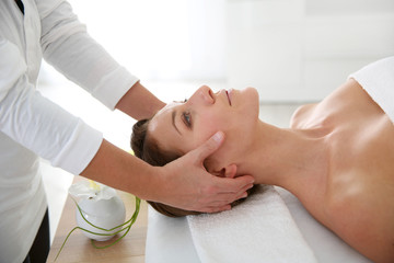Obraz na płótnie Canvas Woman having a face massage in beauty institute
