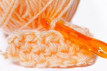 skein of orange yarn closeup and crocheting knitting