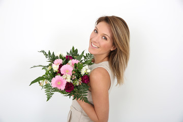 Happy woman holding bunch of flowers
