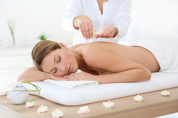 Fototapeta na wymiar Woman in spa institute receiving oil massage
