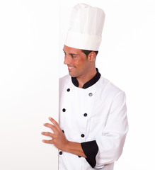 Handsome chef holding a white blank placard