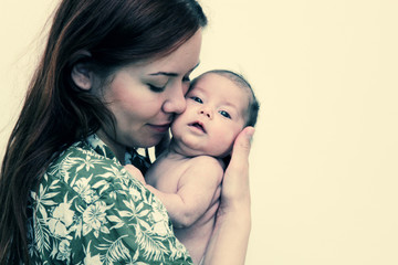 young mother with her baby. Photo in old image style