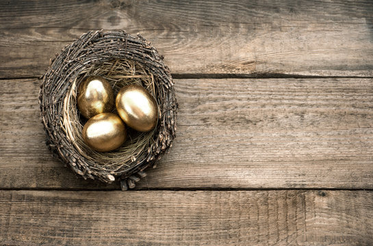 Golden Easter Eggs Over Wooden Background