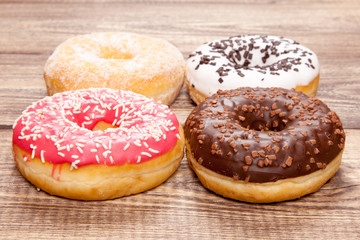 Tasty donuts on a wooden table