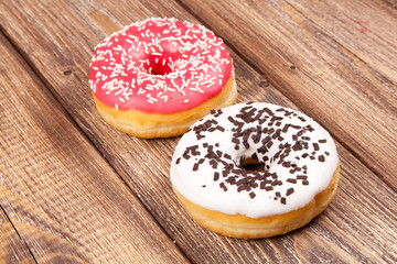 Tasty donuts on a wooden table