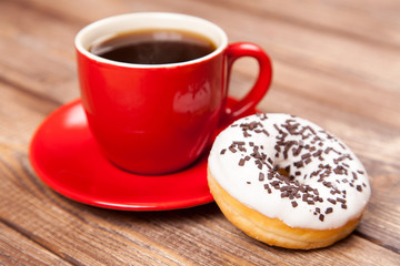 Tasty donut with a cup of coffee