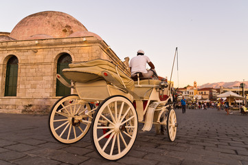 Fototapeta premium Horse carriage in Chania harbor at sunset, Crete