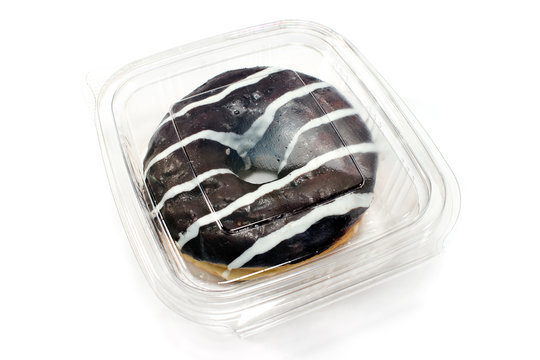 Donut in chocolate glaze in plastic box isolated on white