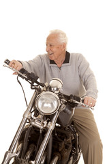 Elderly man on motorcycle look side