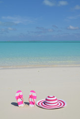 Flip-flops and hat on the beach