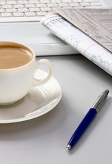 Cup of coffee near press.