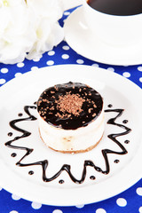 Sweet cake with chocolate on plate on table close-up