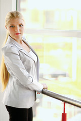 business woman in modern building , standing near windows