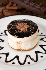 Sweet cake with chocolate on plate on table close-up