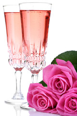 Composition with pink sparkle wine in glasses and pink roses