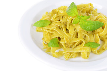 Delicious pasta with pesto on plate close-up