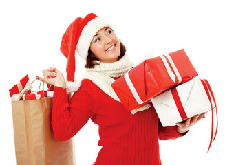 Smiling girl in santa hat with bag full of xmas gift