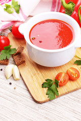 Tasty tomato soup and vegetables, close up