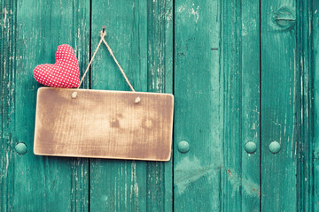 Valentine heart and signboard on vintage planks background