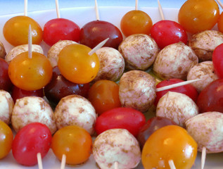Marinated bocconcini and cherry tomatoes on skewers