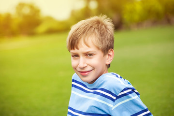 Beautiful happy child playing in a sunny park smiling