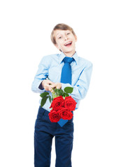 Beautiful romantic boy stretching a bouquet of red roses