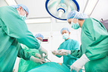 Team surgeon  working in operating room.