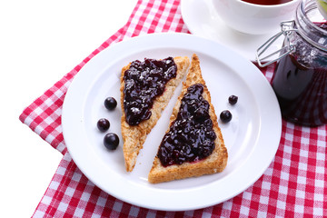Delicious toast with jam on plate close-up
