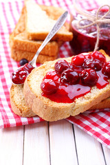 Delicious toast with jam on table close-up