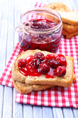 Delicious toast with jam on table close-up