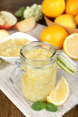 Tasty lemon jam on table close-up