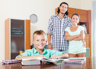 Fototapeta premium Happy schoolboy doing homework