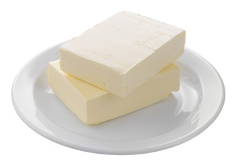 Tasty butter on plate isolated on white