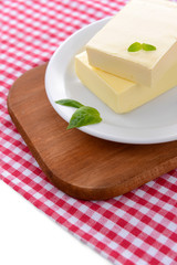 Tasty butter on plate, isolated on white