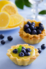 Delicious tarts with lemon cream and blueberries.