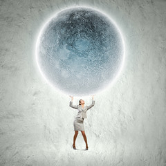 Businesswoman lifting moon