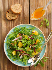 Salad with oranges, arugula, walnuts with vinaigrette.