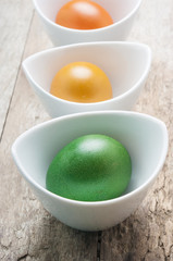 Colorful easter eggs on wooden background