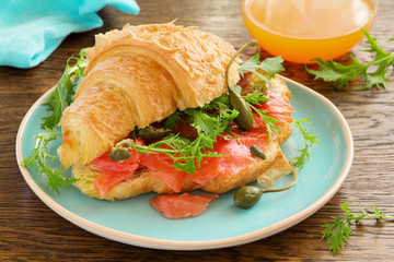Croissant with salmon and capers.