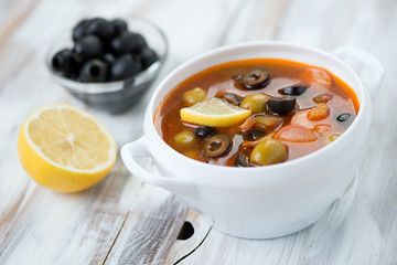 Solyanka soup with meat, sausage and olives, horizontal shot