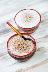 Russian traditional dish - boiled buckwheat with milk