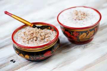 Russian traditional cuisine - boiled buckwheat served with milk
