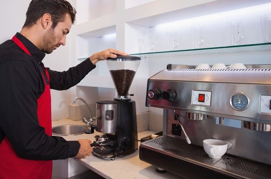 Handsome Barista Grinding Coffee Beans