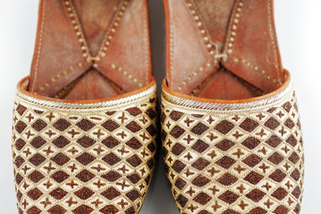 Traditional Arabic slippers shot against a white background