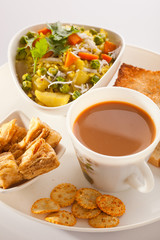 Breakfast- Tea, Poha with bread and Biscuit.