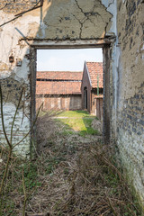 Look through the doorway of a dilapidated house